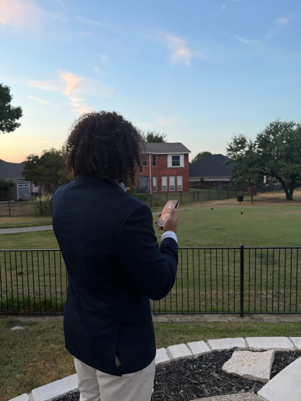 Ejay Weaver on his phone outside a family's home